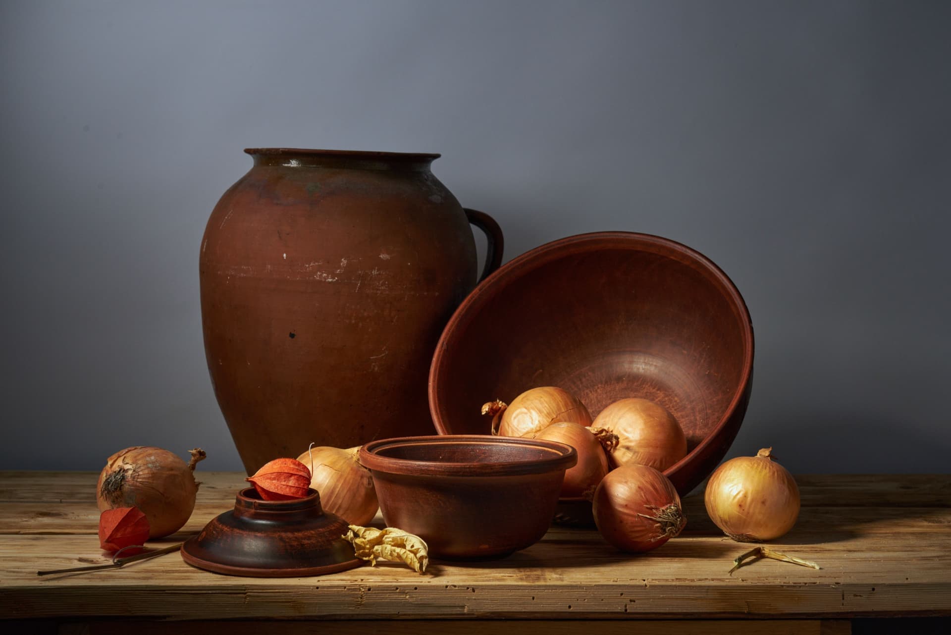 A glazed stoneware crock standing on a wooden kitchen surface