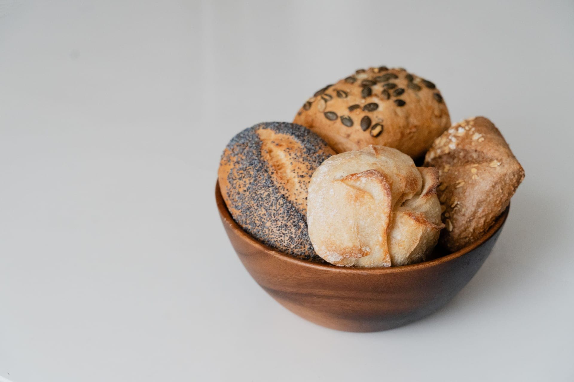A bowl of whole-grain rye flour on a bare surface