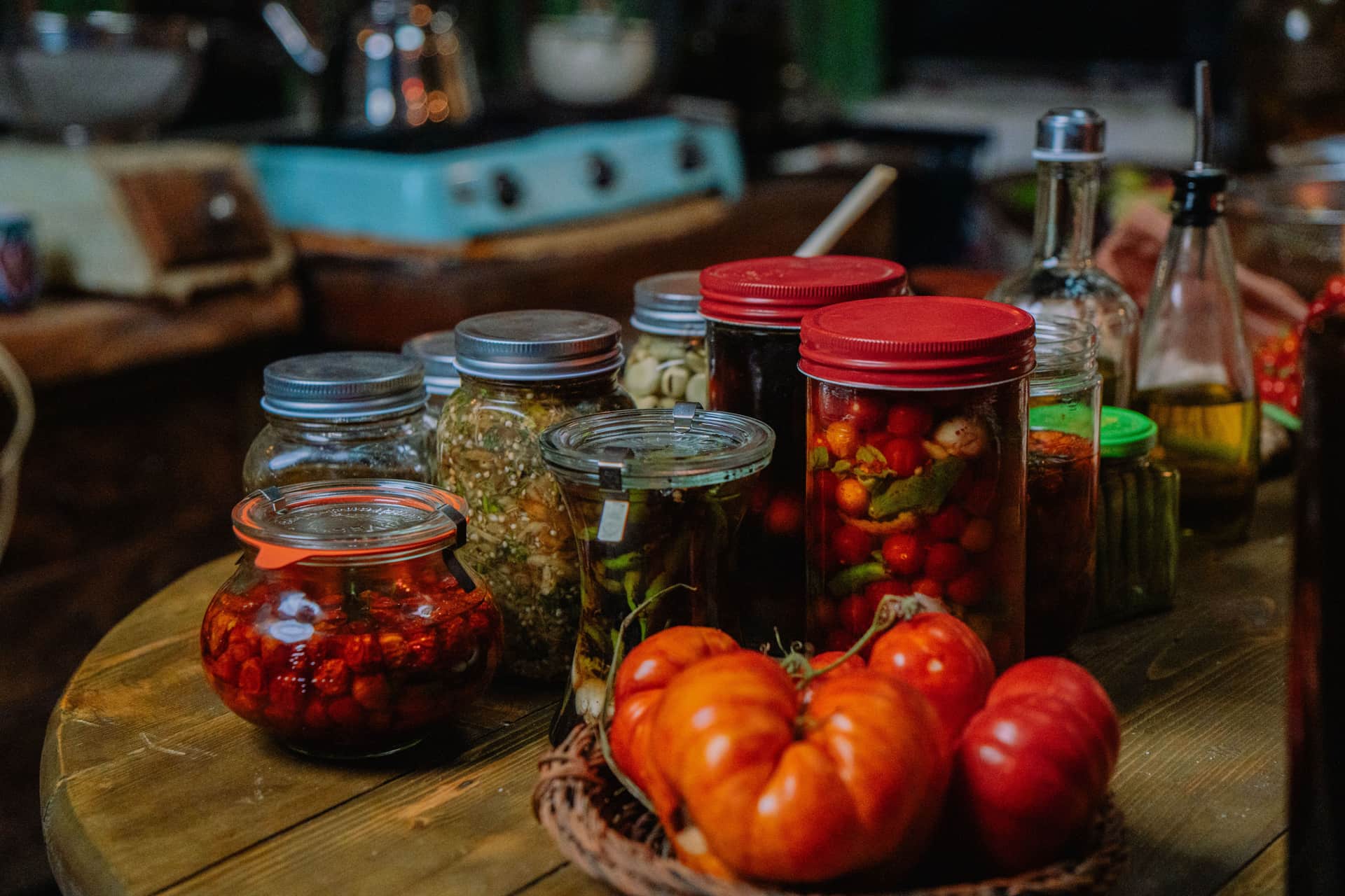 Jars of preserved vegetables on a kitchen shelf