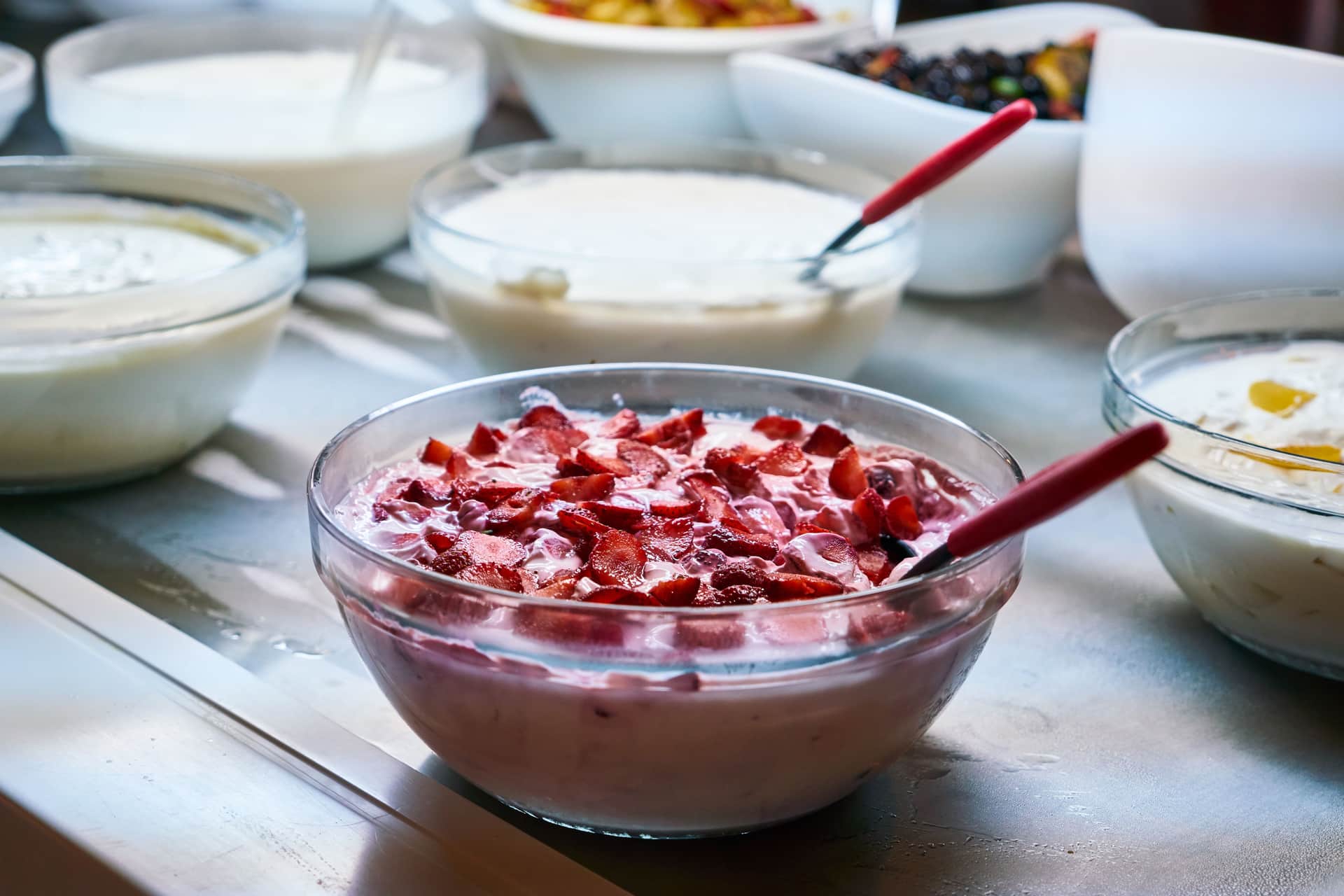 Bowls of homemade yogurt with fresh fruit toppings
