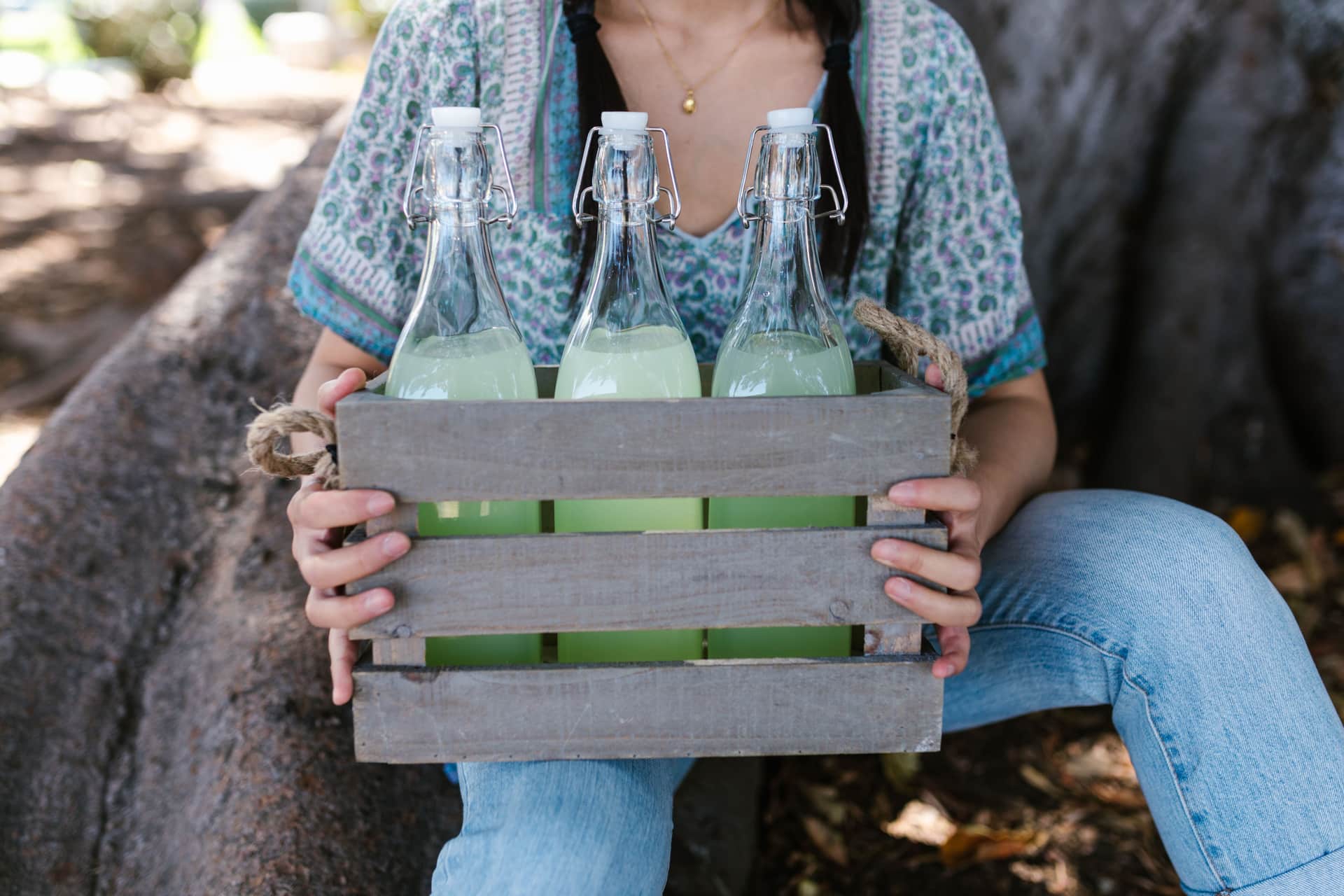Swing-top glass bottles carried in a wooden crate