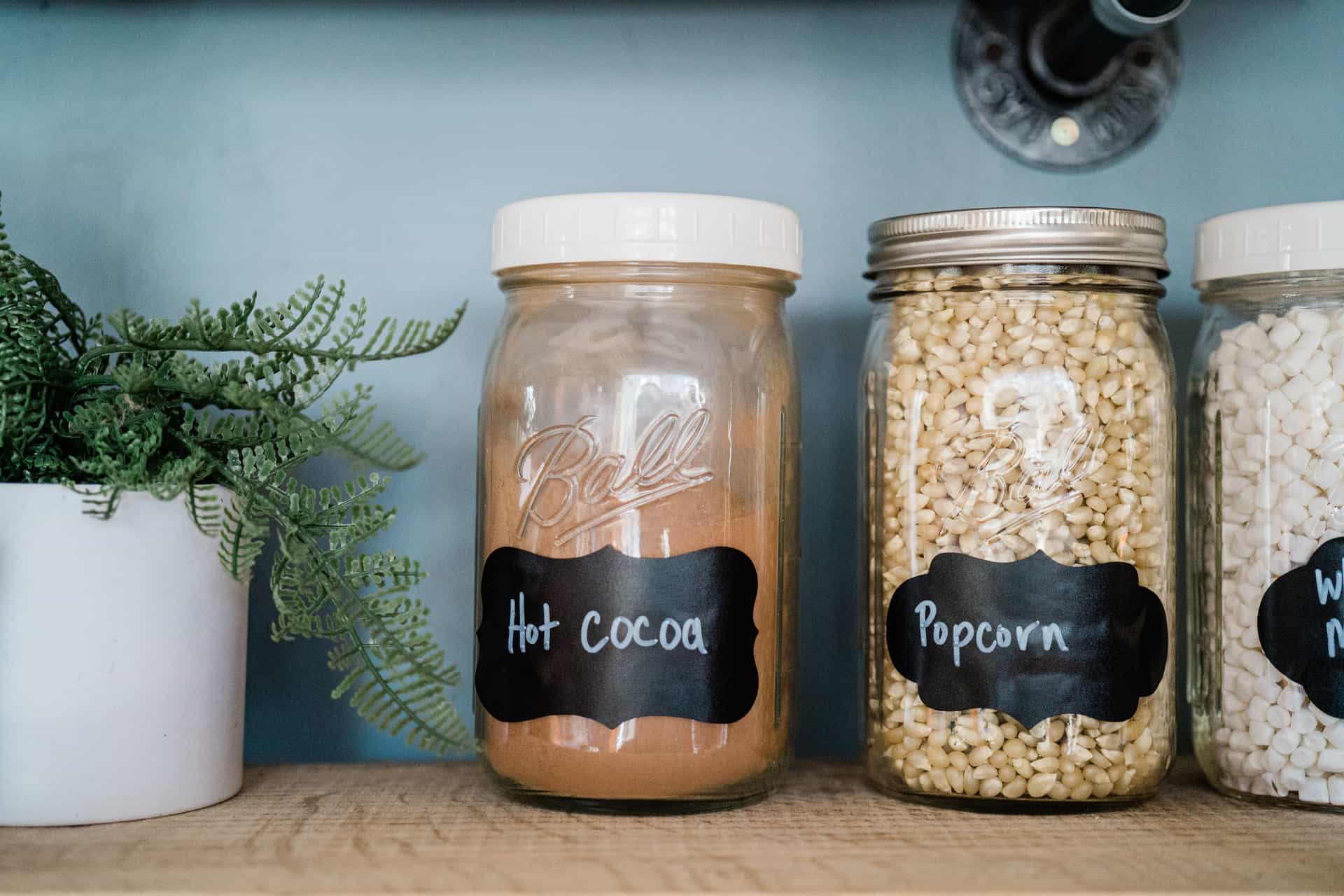 Metal canning jar rings and lids stacked on a plain surface
