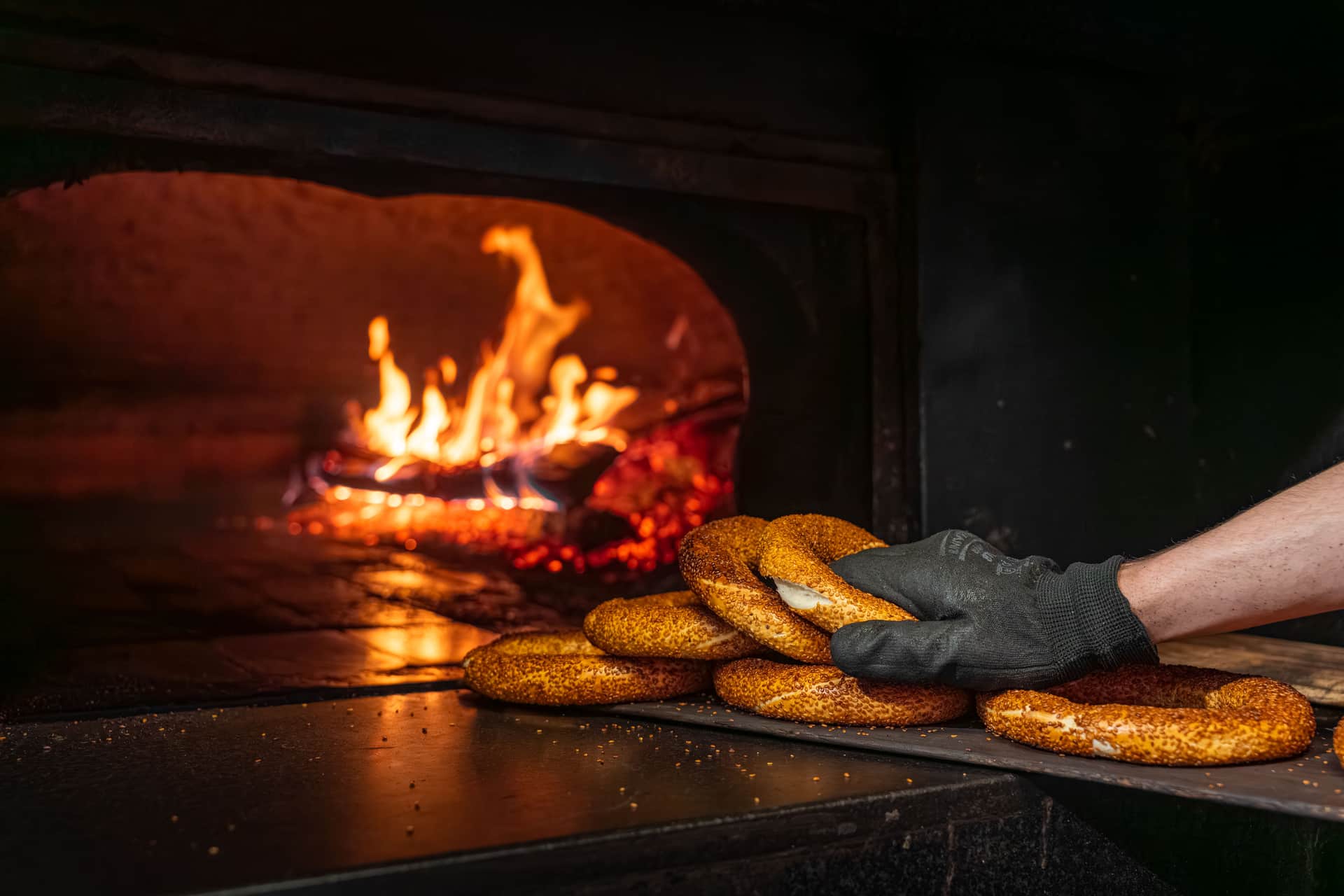 Steam rising around a loaf of bread inside a hot oven