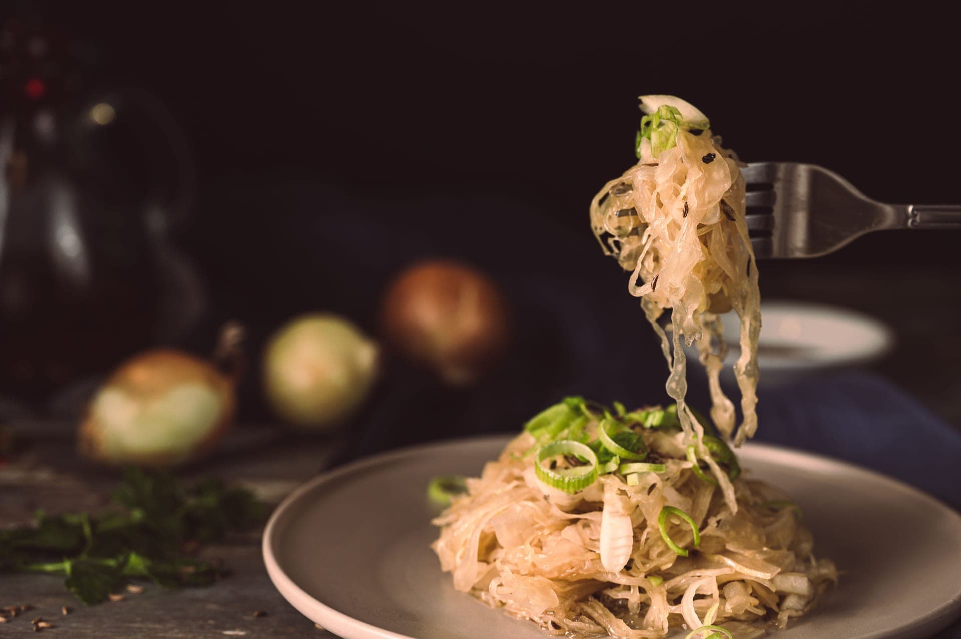 Shredded cabbage and coarse salt in a wide mixing bowl
