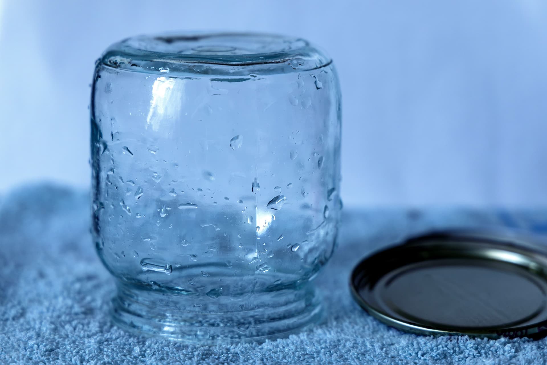 Round glass discs beside an empty preserving jar