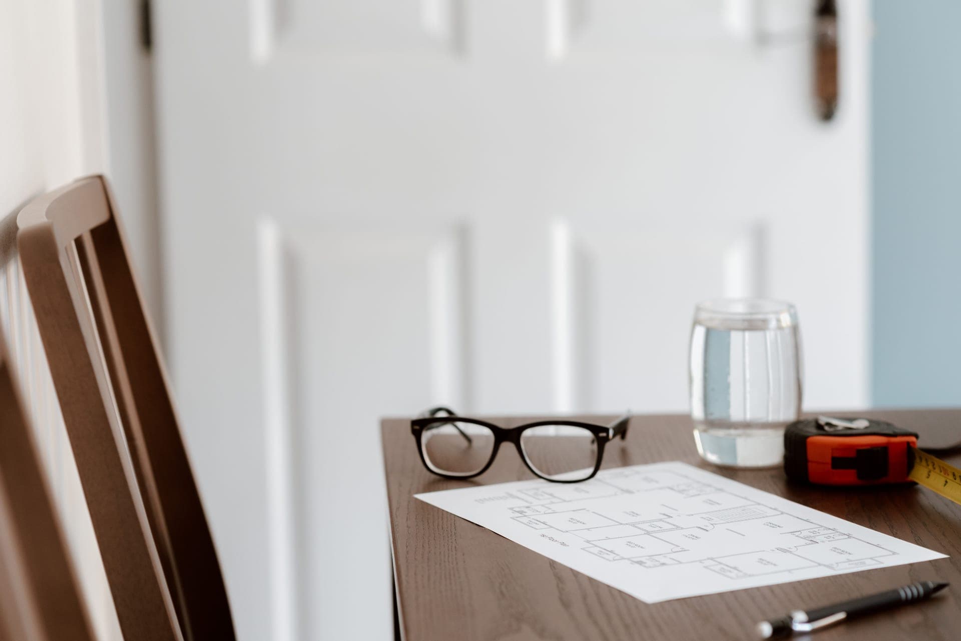 Printed specification sheets and a measuring tool laid out on a desk
